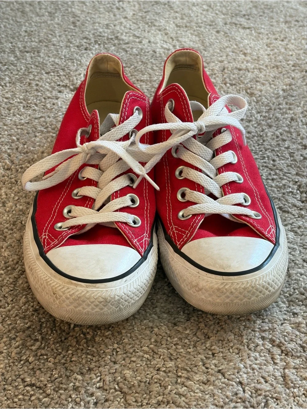 Converse red low-top sneakers with white laces